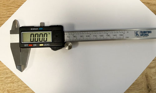 Full view of digital caliper showing jaws, beam, display and thumb roller