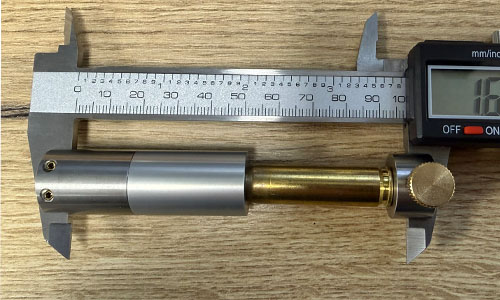 Digital caliper with Derraco comparator insert measuring the shoulder bump of a brass case